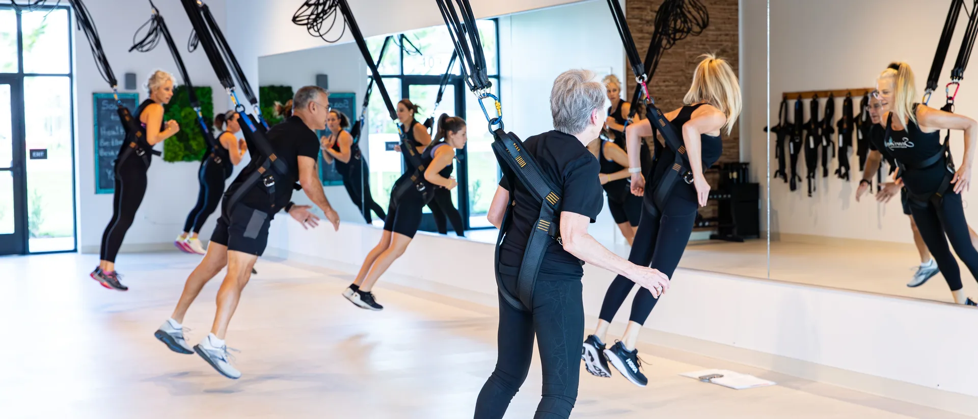 A full class mid-flight, every member airborne in their bungee harness